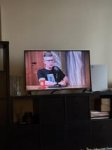 May be an image of 1 person and television