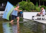May be an image of 3 people and people swimming